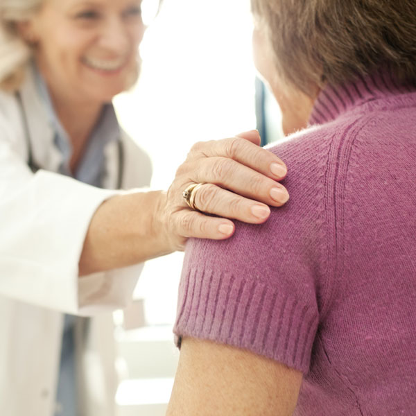 physician talking to elderly woman