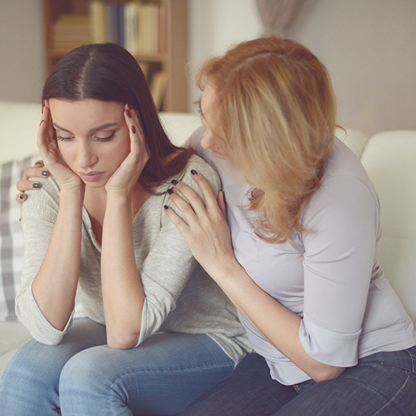 young woman comforting worried friend
